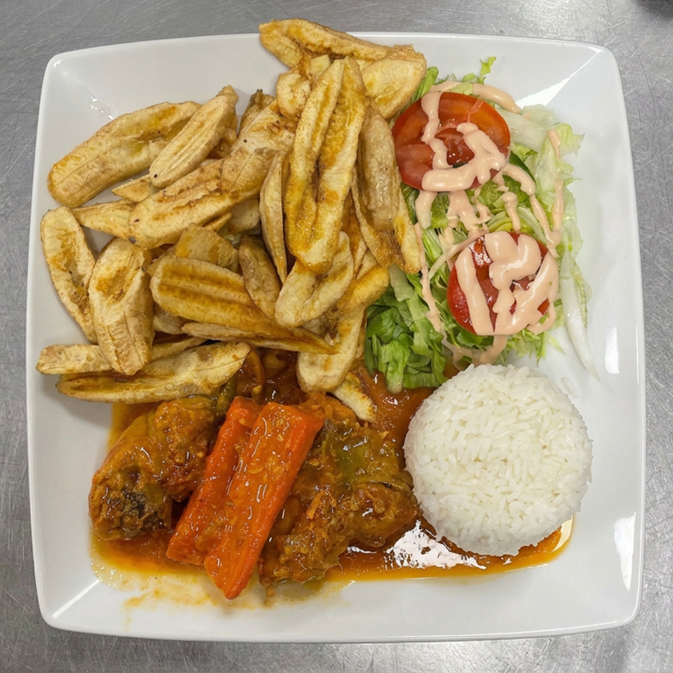 Plate of stewed meat and vegetables with white rice, fried plantains, and lettuce salad topped with pink dressing.